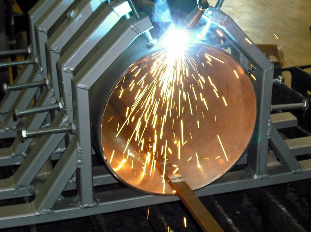 Laser welding a steel pipe in a fixture with sparks