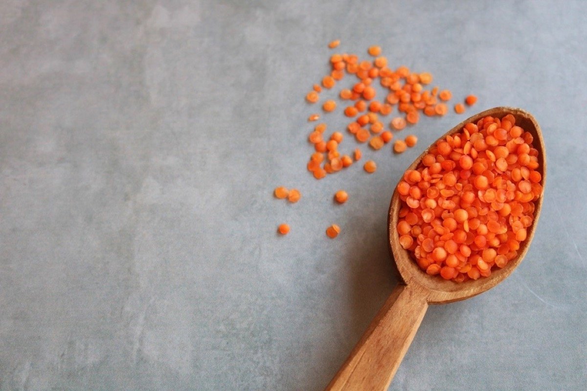 Split red lentils (masoor dal) on a wooden spoon