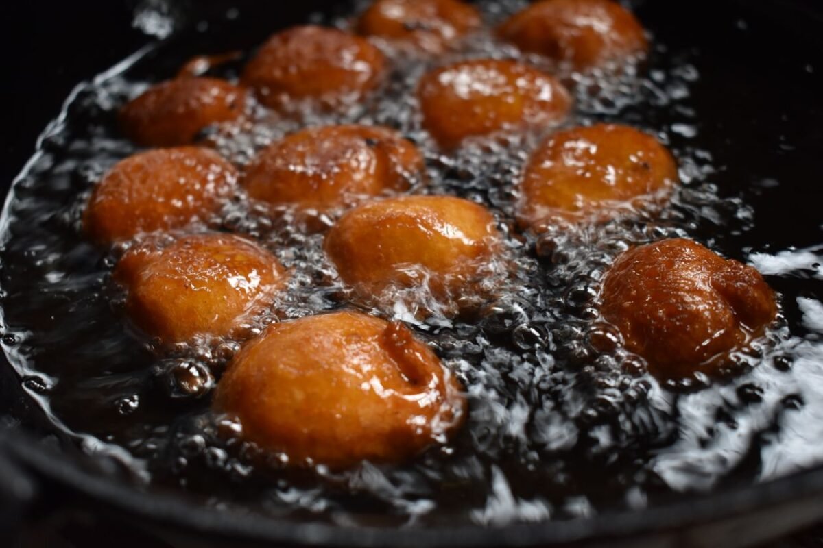 Dough snacks frying in hot oil